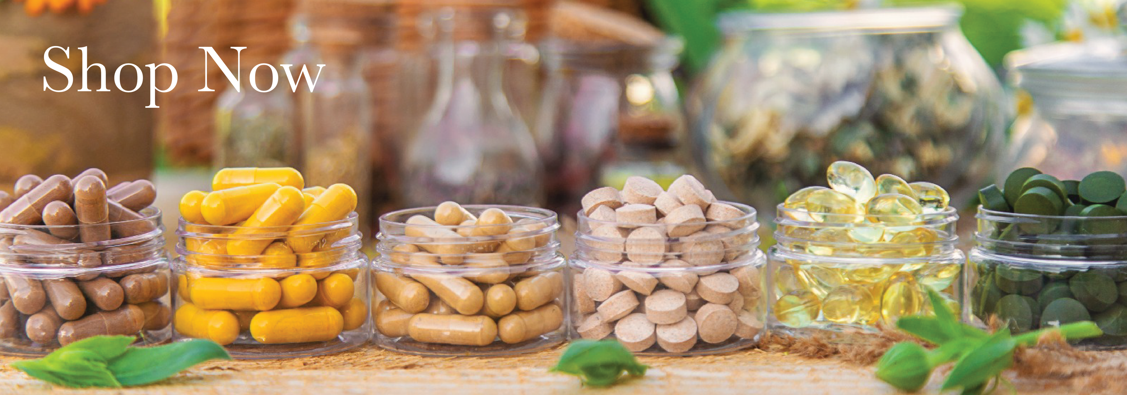 Assorted health supplements in glass jars on a wooden surface with 'Shop Now' text.
